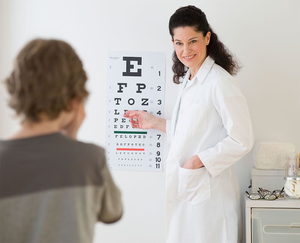 Woman giving eye exam to kid