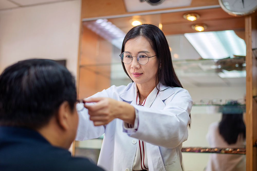 Female optometrist holding eyeglasses