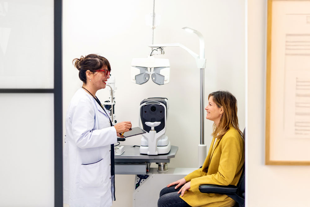 Vision through a door of an optometrist talking to a patient in a clinic