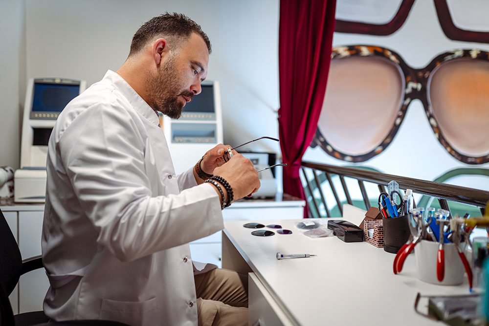 Ophthalmic laboratory technician working on new glasses